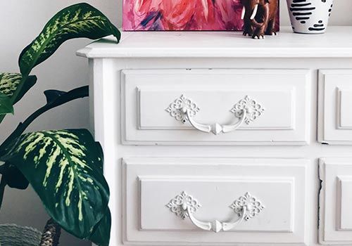plan and white dresser with ornate handles