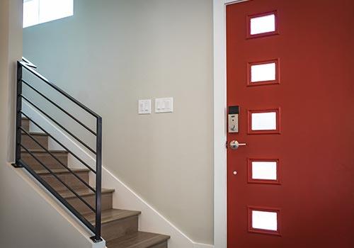 stair case and red door with six small windows